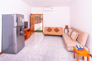 a living room with a refrigerator and a couch at All INCLUSIVE GALAPAGOS & BEYOND 2 in Puerto Ayora