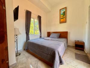 Ένα ή περισσότερα κρεβάτια σε δωμάτιο στο Jingga Guesthouse