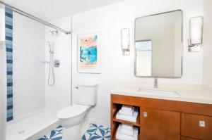 a bathroom with a toilet and a sink and a mirror at St Thomas Luxury Beach Resort in Nazareth