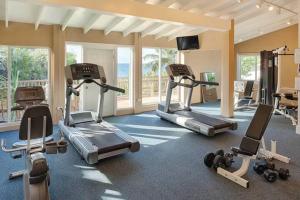 a gym with several treadmills and exercise bikes at St Thomas Luxury Beach Resort in Nazareth