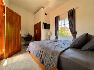 Ένα ή περισσότερα κρεβάτια σε δωμάτιο στο Jingga Guesthouse