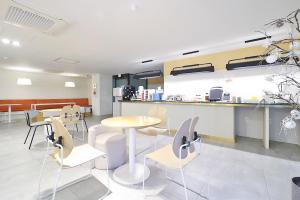 a restaurant with tables and chairs and a counter at Brown Dot Hotel Ulsan Samsan in Ulsan