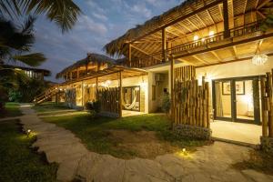 an exterior view of a house at night at Panorama garden inn in Máncora