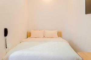 Postel nebo postele na pokoji v ubytování Mylan Hotel Đà Lạt by HOFs