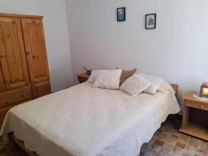 a bedroom with a bed with two pillows on it at Casa Emilia Tanti in Tanti