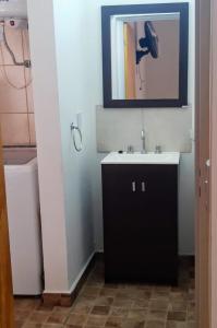 a bathroom with a sink and a phone on the wall at Casa Emilia Tanti in Tanti