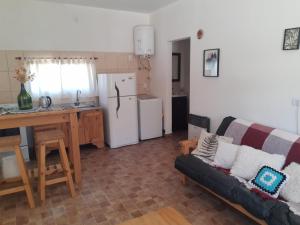 a living room with a couch and a kitchen at Casa Emilia Tanti in Tanti +13 photos