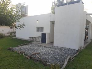 a white building with a door on the side of it at Casa Emilia Tanti in Tanti