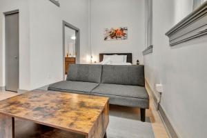 a living room with a couch and a table at Bright and Modern Studio in Louisville # 304 in Louisville +55 photos
