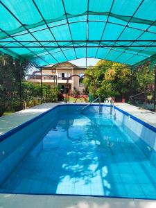an overhead view of a swimming pool with a blue roof at Elenem Resort in Magalang