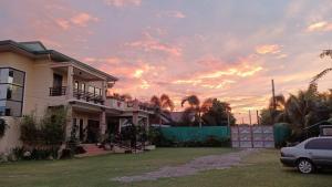 a house with a car parked in front of it at Elenem Resort in Magalang