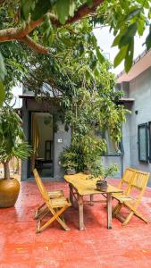 two chairs and a wooden table and bench on a patio at Vĩnh Hy House in Ninh Hải +37 photos