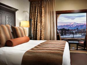 a hotel room with a large bed and a large window at The Lodge at Flying Horse in Colorado Springs