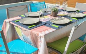 a table with a colorful table cloth and plates on it at Villa Saline in La Saline les Bains