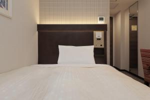 Postel nebo postele na pokoji v ubytování Keio Presso Inn Nihonbashi Kayabacho