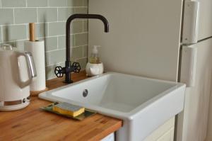 a sink in a kitchen next to a refrigerator at garazi in Saint-Jean-Pied-de-Port