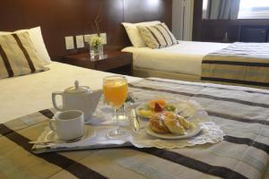 Postel nebo postele na pokoji v ubytování Bisonte Palace Hotel