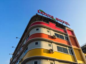 a building with a hotel sign on top of it at Louis Hotel in Taiping