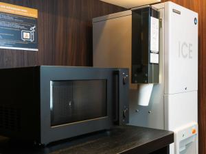 a microwave oven sitting on a counter next to a refrigerator at APA Hotel & Resort Osaka Namba Ekimae Tower in Osaka
