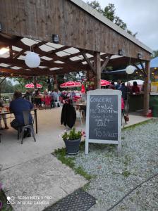 a sign in front of a building with a restaurant at le hangar 87 in Bussière-Portevine