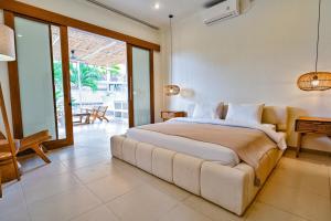 a bedroom with a large bed in a room at great 3-bedroom Villa Near Canggus Top Attractions in Canggu +23 photos