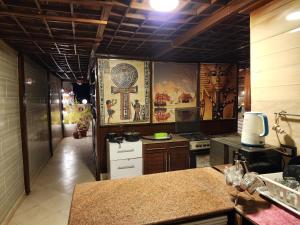 une cuisine avec une croix peinte sur le mur dans l'établissement private rooftop with hot jacuzzi and pyramids view, à ‘Ezbet `Abd el-Ḥamîd