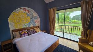拜县Zuu Tee的一间卧室,里面有一张床和一扇大窗户。