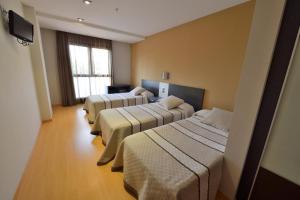 Posteľ alebo postele v izbe v ubytovaní Hotel Ciutat d'Amposta