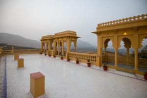 a view of a building with columns and a balcony at ELIVAAS Amber Royale 3 BHK with Pvt Pool & Terrace in Udaipur