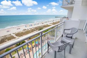 a balcony with two chairs and a view of the beach at Atlantica 753 in Myrtle Beach