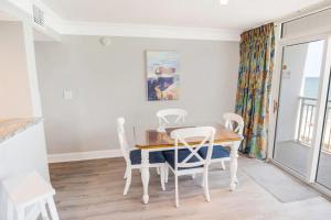 a dining room with a table and chairs at Atlantica 753 in Myrtle Beach +14 photos