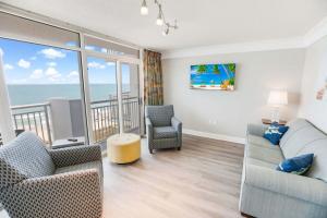 a living room with a couch and chairs and the ocean at Atlantica 753 in Myrtle Beach