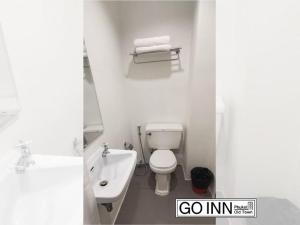 a bathroom with a white toilet and a sink at GO INN Phuket Old Town ภูเก็ตโอลทาวน์ ย่านเมืองเก่า in Phuket