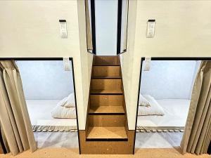Postel nebo postele na pokoji v ubytování HOTEL minimumms女性専用カプセルホテルWomen only hotel