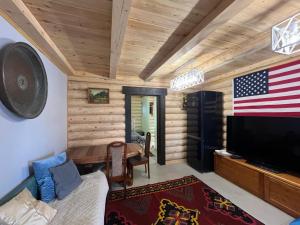 a living room with an american flag on the wall at Etalon in Taldybulak