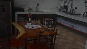 a dining room table with a bottle of wine on it at Yarumo Lodge, Río Celeste Black Chalets in Bijagua