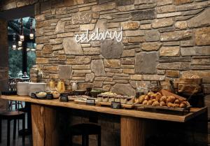 a stone wall with a table with food on it at Slow Tatry Boutique Resort&SPA in Zakopane