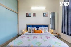 a bedroom with a large bed with orange pillows at StayVista at Ikigai - Pool, AC & Terrace in Udaipur +14 photos