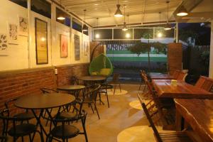 a room with tables and chairs in a restaurant at Famoris Cottages in Tetebatu