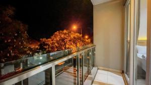 a balcony with a view of a city at night at AIVY Living by AIVY ID Official in Bandung +27 photos