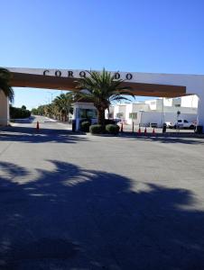 a parking lot with palm trees and a building at Casa con casa club en la Paz BCS in La Paz
