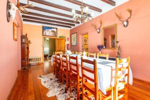 a dining room with a long table and chairs at Mas Vell in Catí