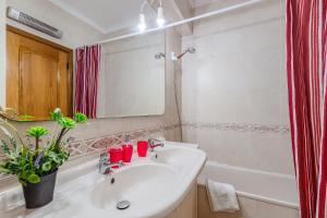 a bathroom with a sink and a mirror and a tub at Setúbal Dreams in Setúbal +23 photos