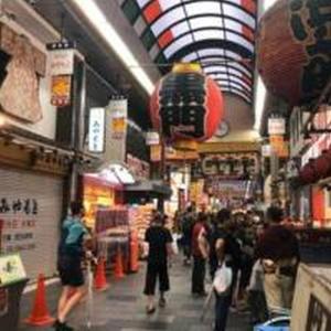 a group of people walking through a shopping mall at Mutsumi Konohana 601 むつみ庵此花 601 in Osaka