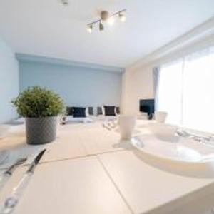a bathroom with a sink and a potted plant at Mutsumi Konohana 601 むつみ庵此花 601 in Osaka