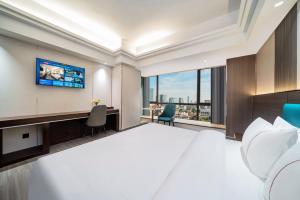 Postel nebo postele na pokoji v ubytování Mei Gang Hotel
