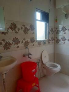a bathroom with a toilet and a sink and a window at ILIF 2726 Beach Haven in Nāgaonkhar +18 photos