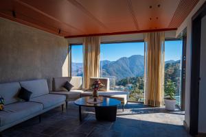 a living room with a couch and a table at Checkmate in Mussoorie