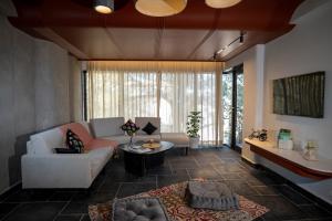 a living room with a couch and a table at Checkmate in Mussoorie