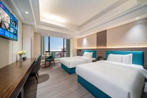 Postel nebo postele na pokoji v ubytování Mei Gang Hotel